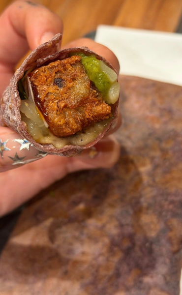 Dua Lipa holding food with a star manicure